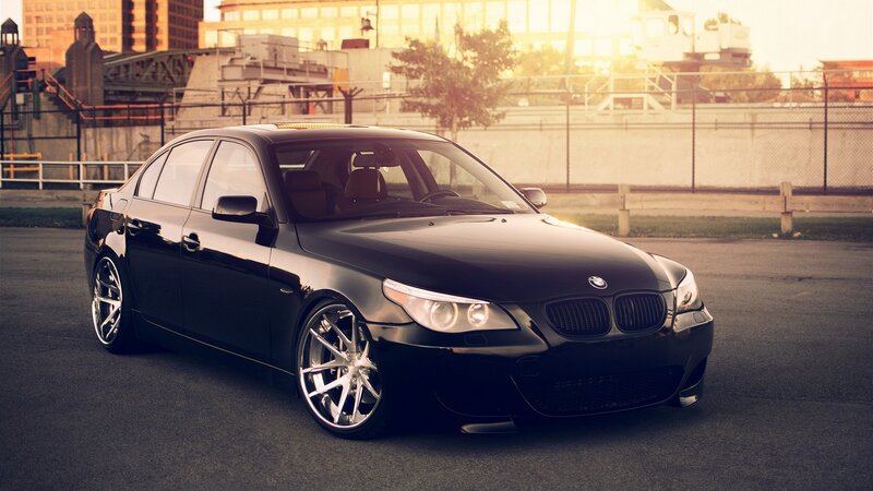 black bmw sedan in urban setting