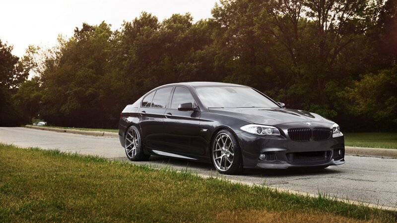 Black BMW sedan on a road