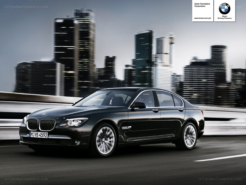 Black BMW sedan on city bridge