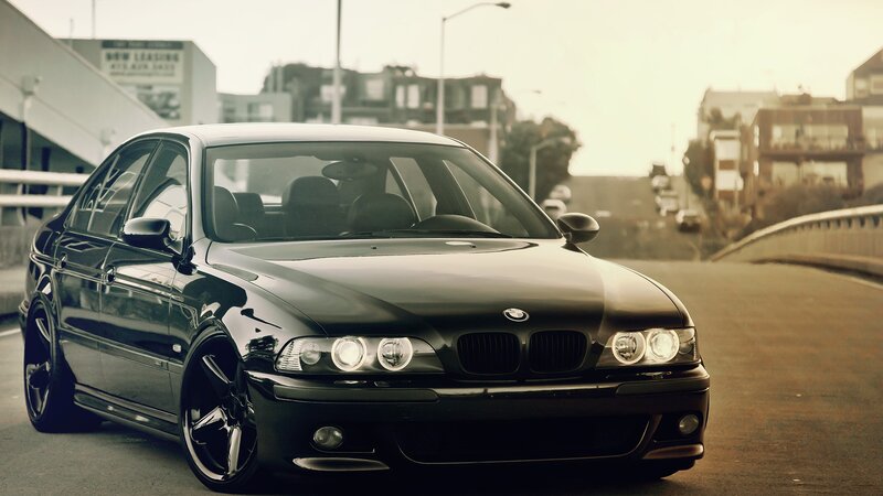 black bmw sedan on city road