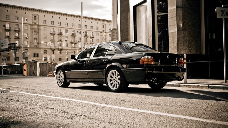 black bmw sedan on city street