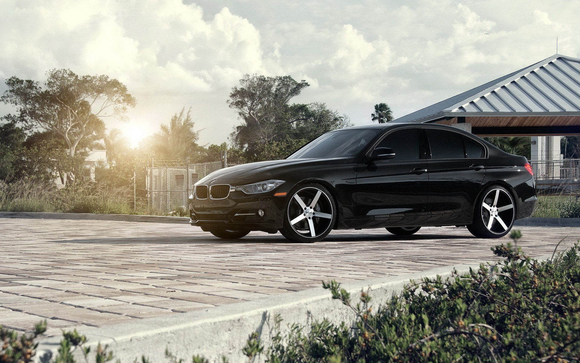 black bmw sedan on cobblestone