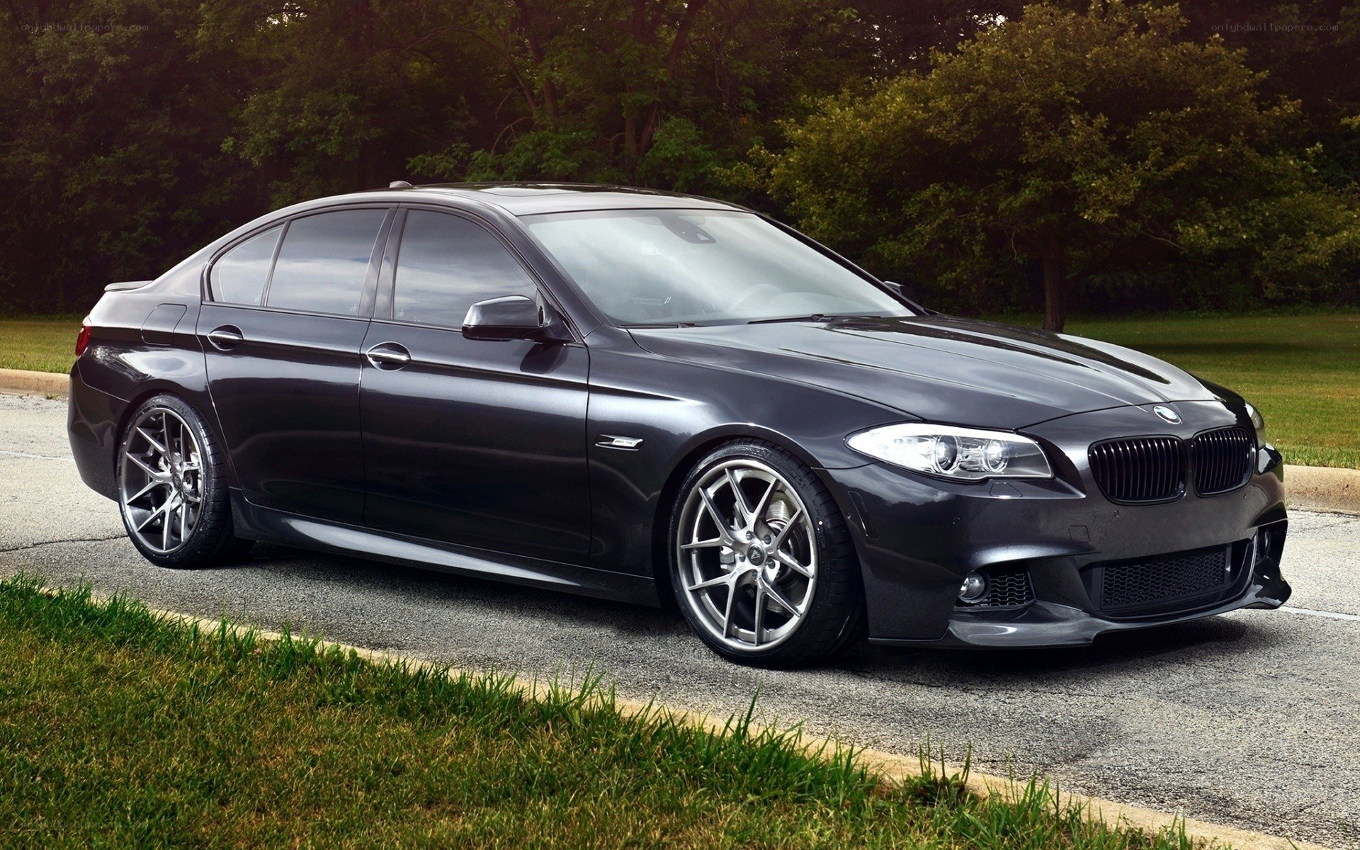 Black BMW sedan on pavement
