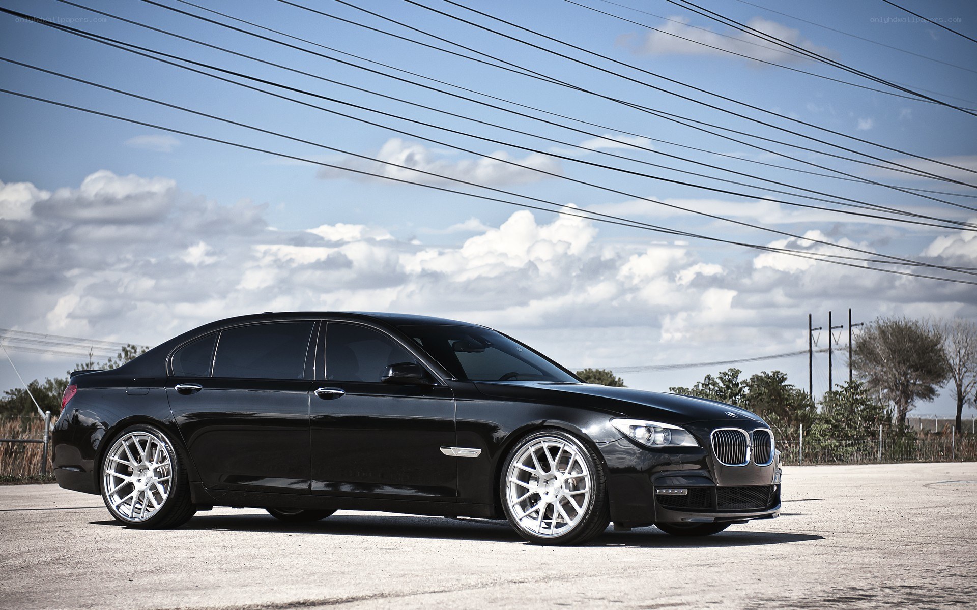 Black BMW sedan on pavement