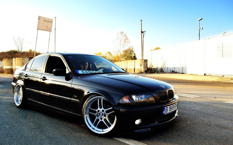 Black BMW sedan on street