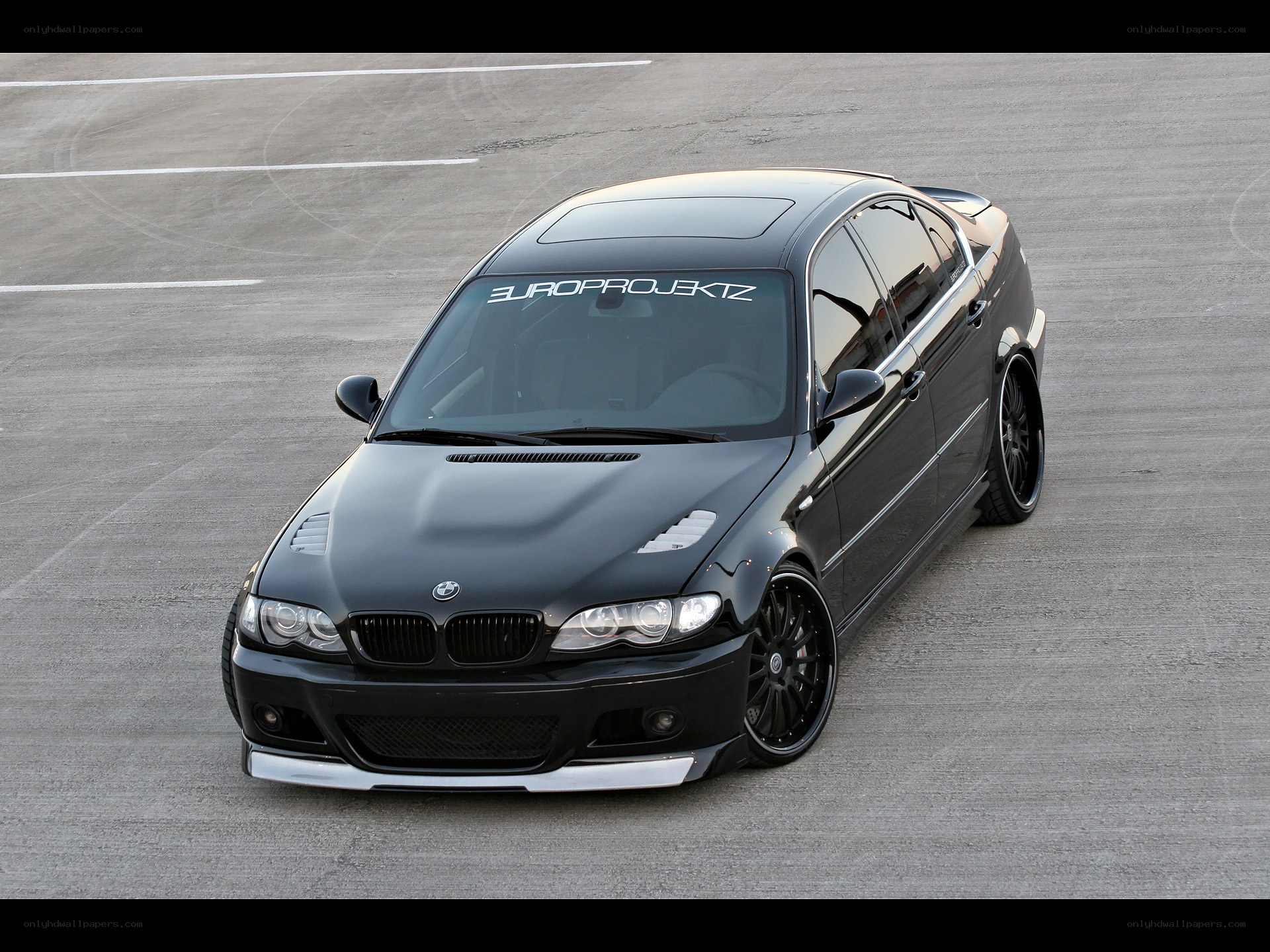 black bmw sedan on track