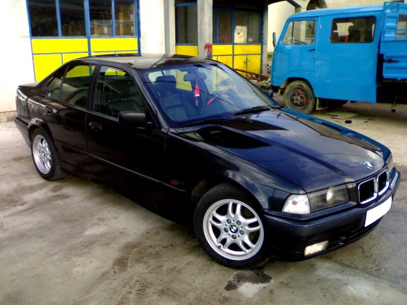 Black BMW sedan parked outside