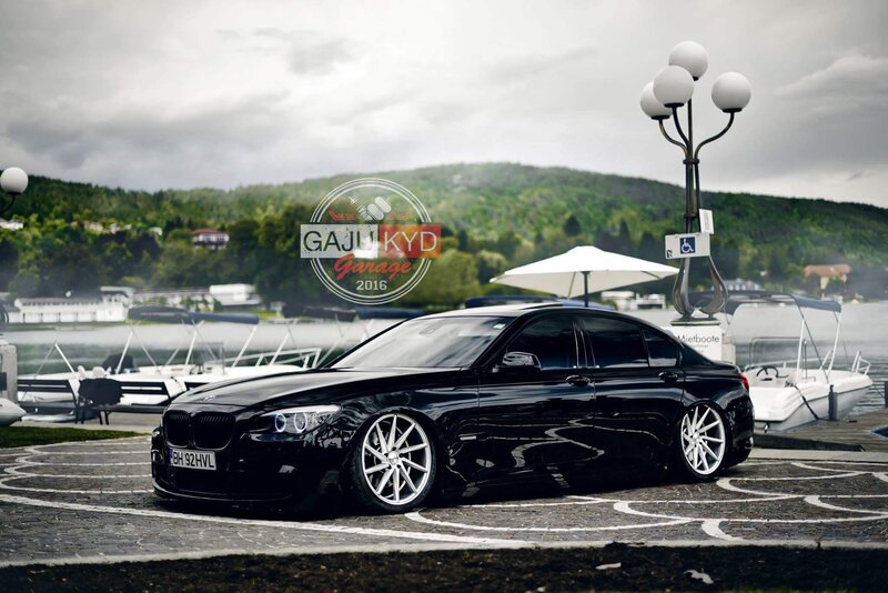 Black BMW Sedan — Serene, Afternoon, Photograph, Boats