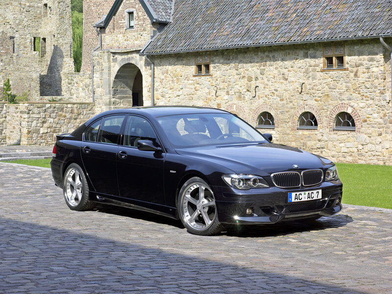 Black BMW Sedan — Serene, Afternoon, Photograph, Stone Building