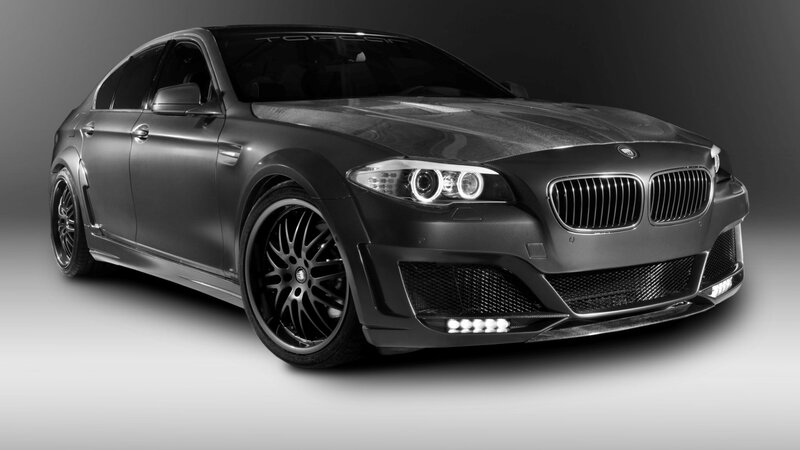 black bmw sedan with carbon fiber