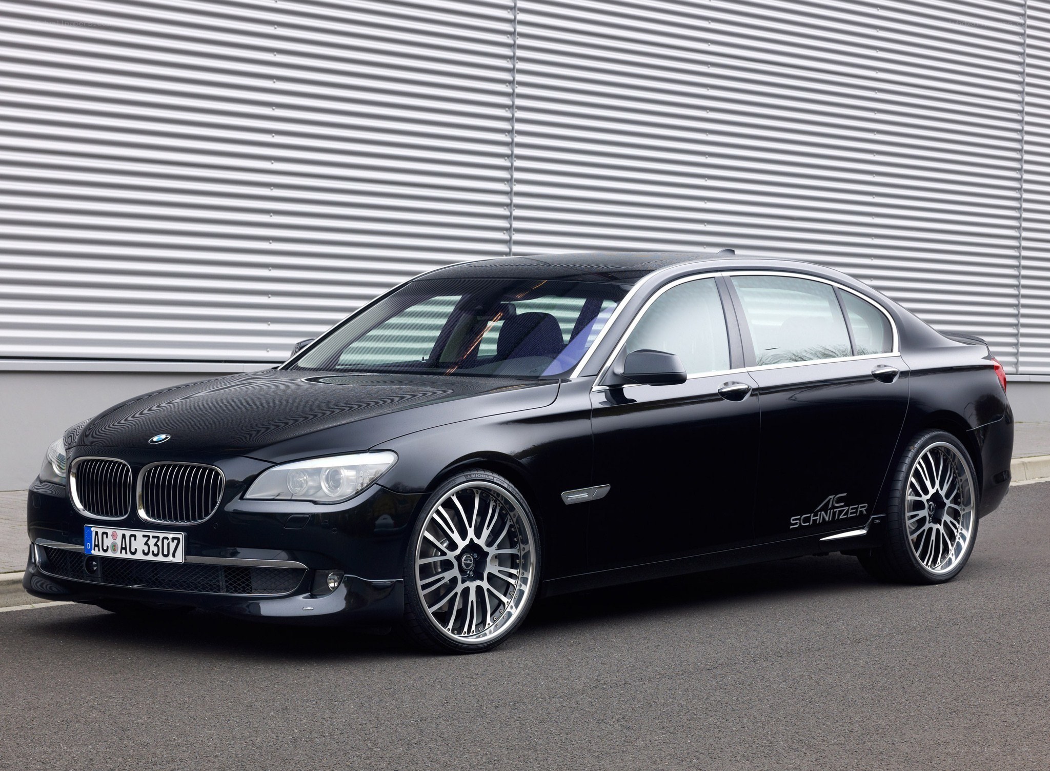 black bmw sedan with custom wheels