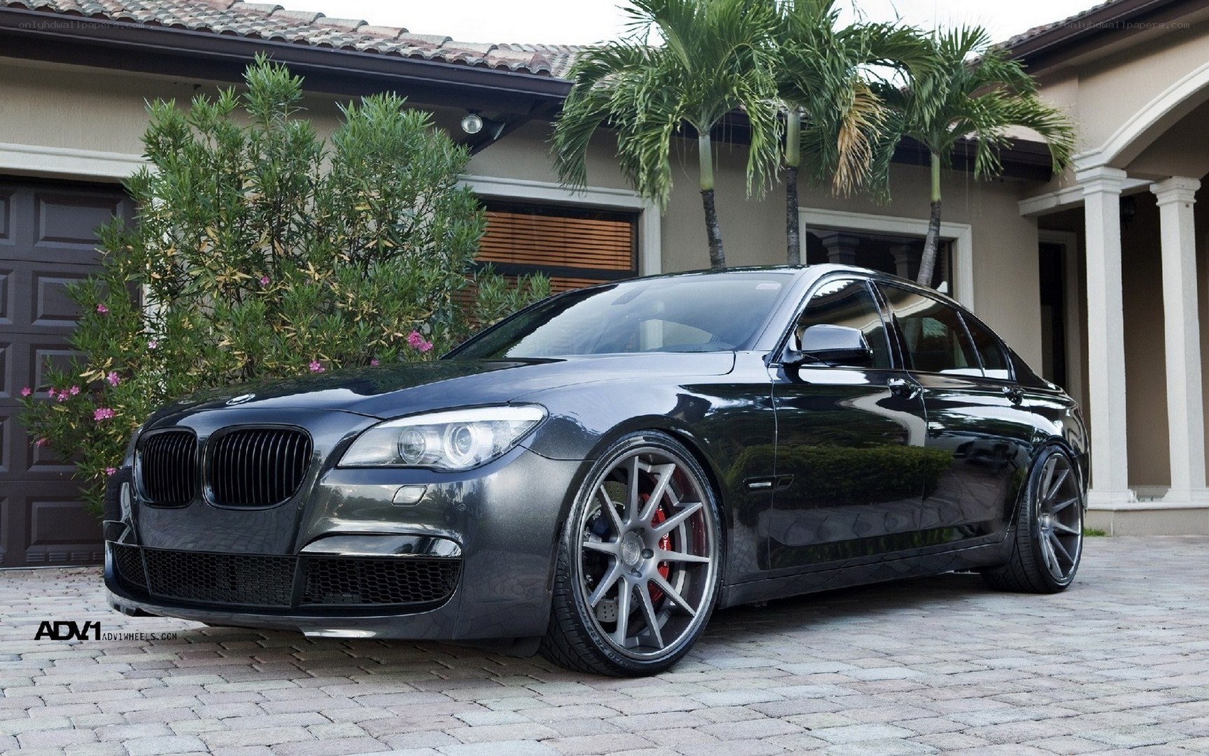 Black BMW sedan with custom wheels
