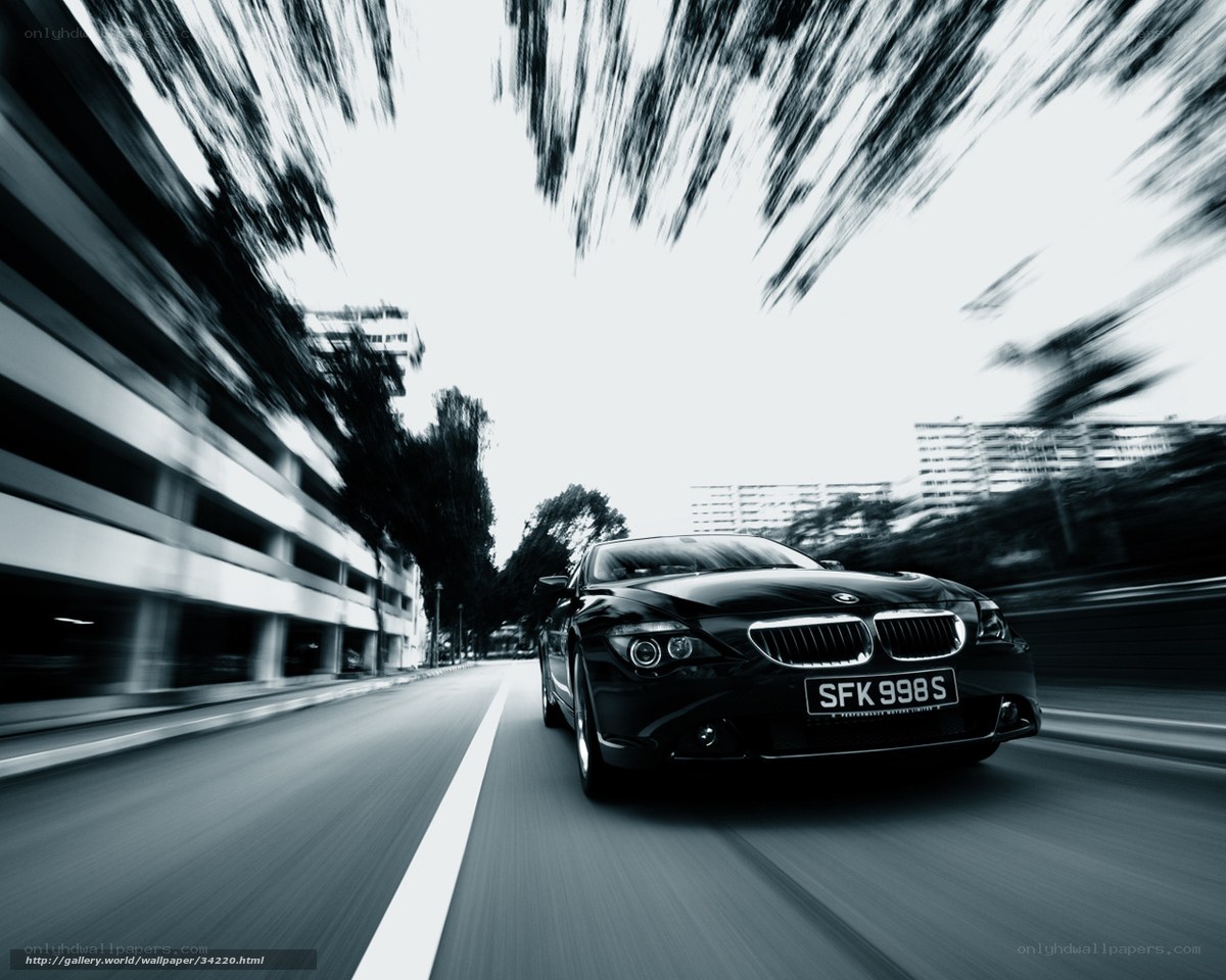 Black BMW speeding on city street