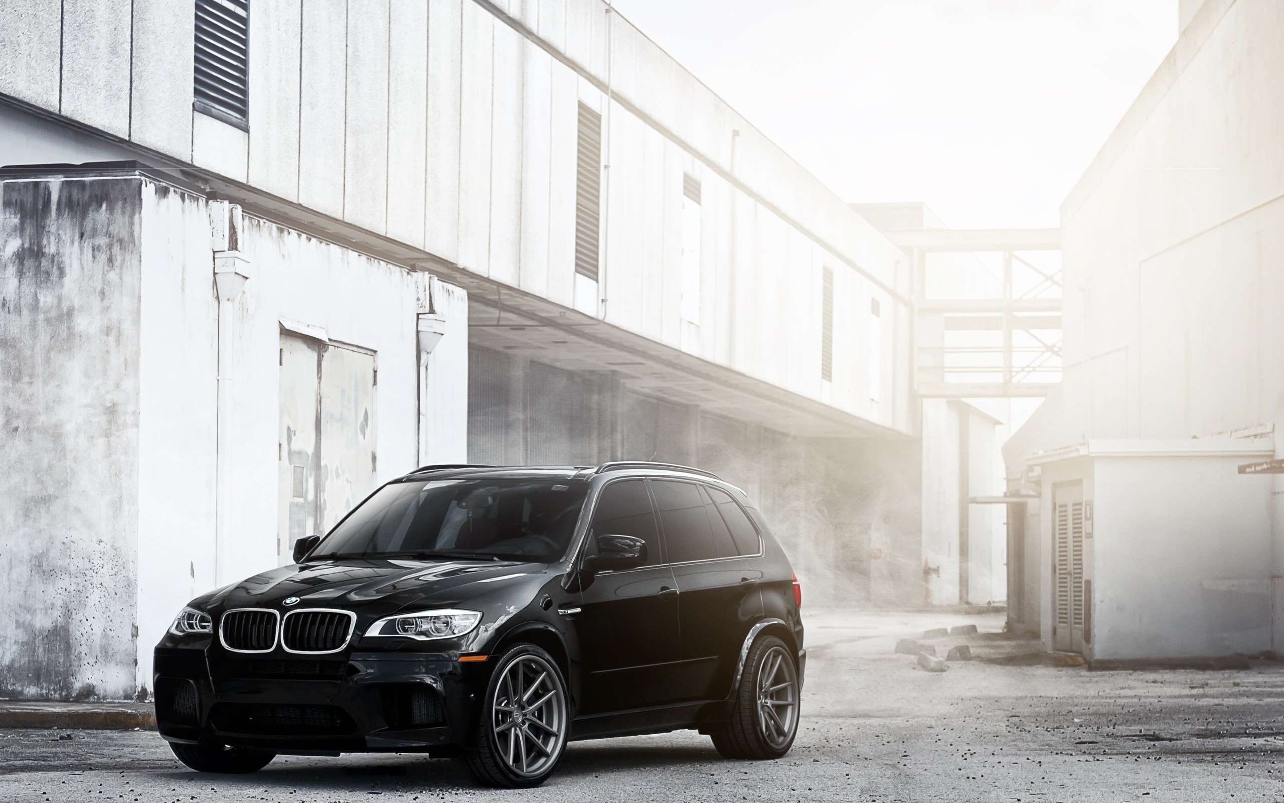Black BMW SUV in industrial setting