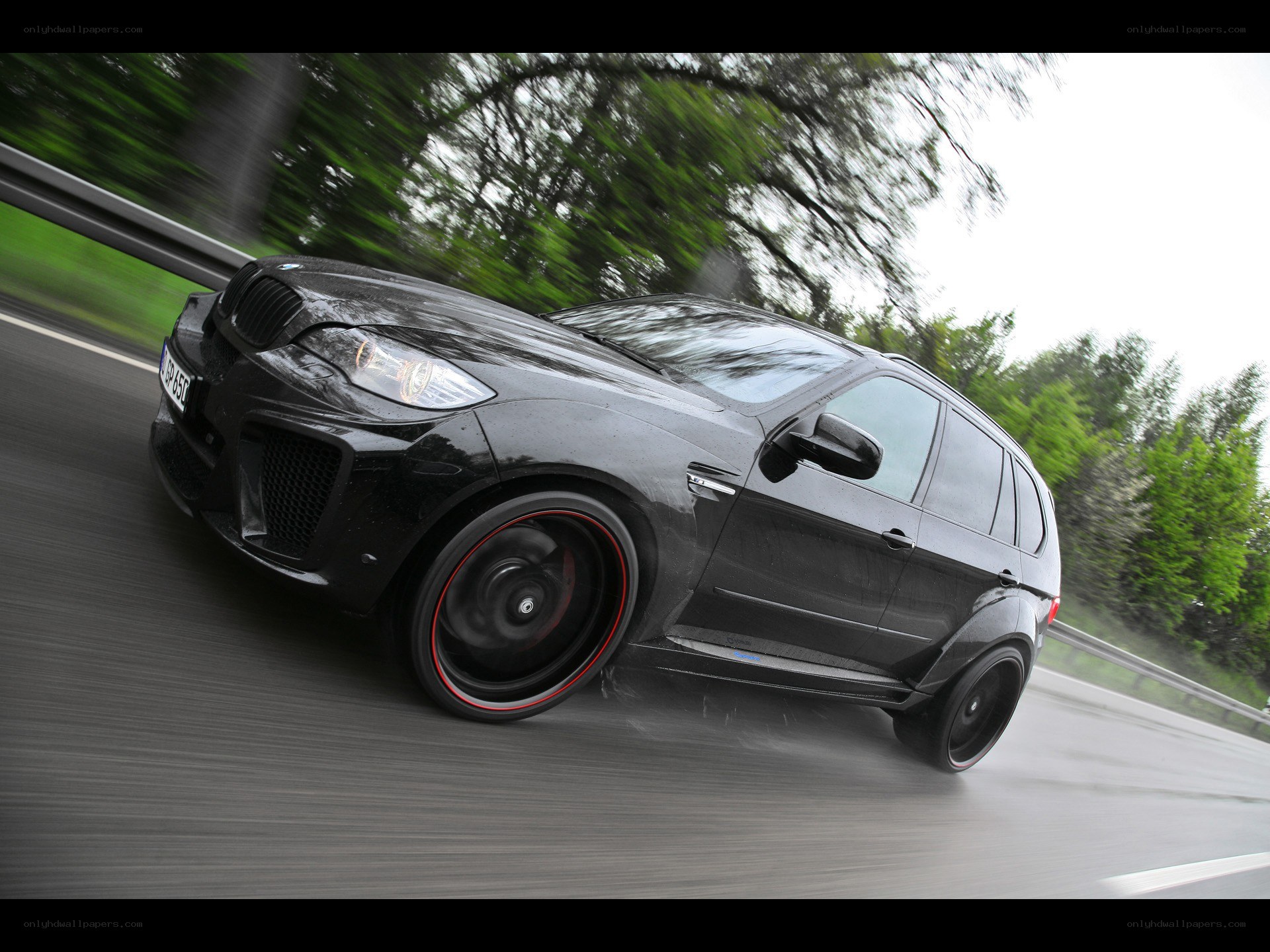 Black BMW SUV in motion