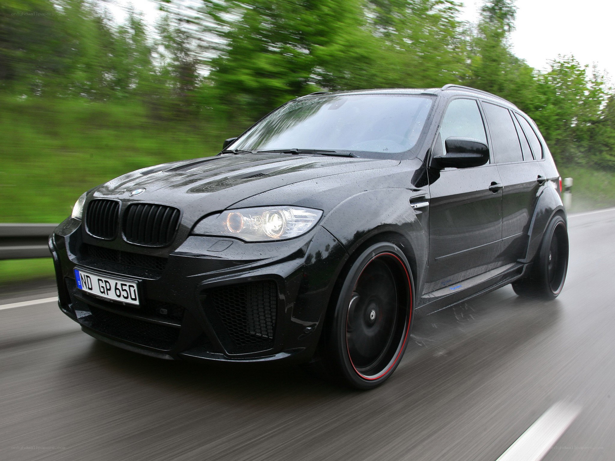 black bmw suv in motion