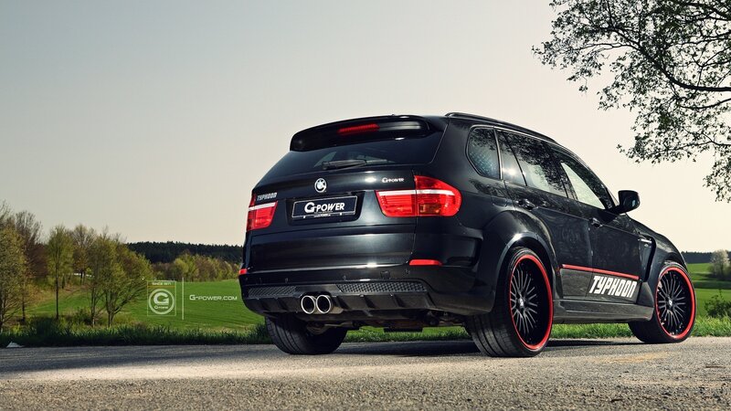Black BMW SUV on country road