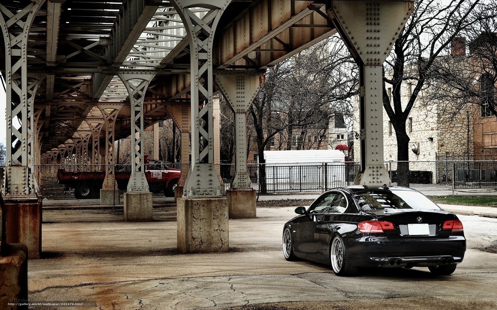 Black BMW under a bridge