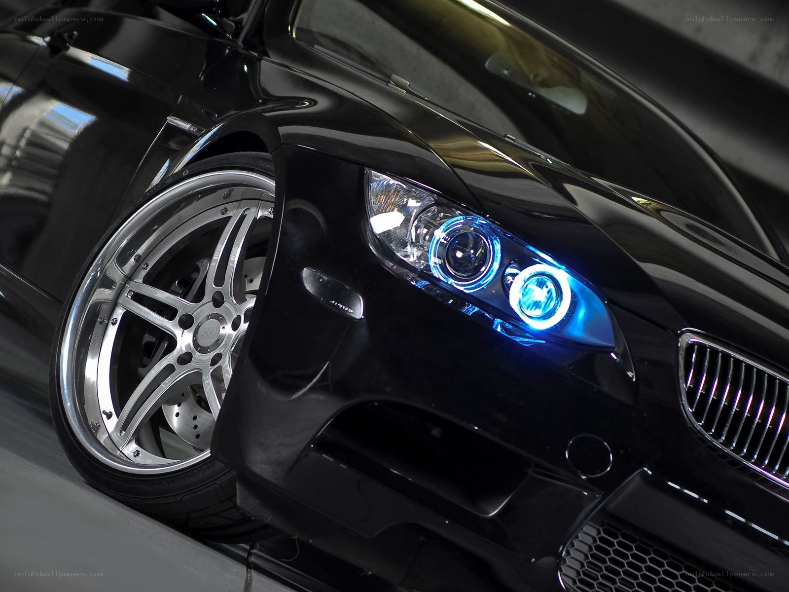 Black BMW with blue headlights