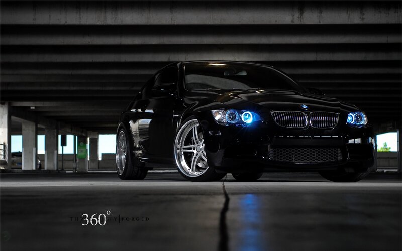Black BMW with blue headlights