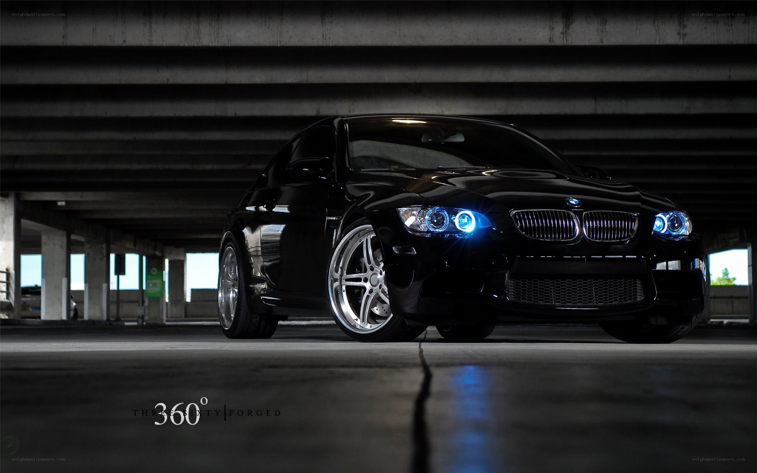 Black BMW with blue headlights
