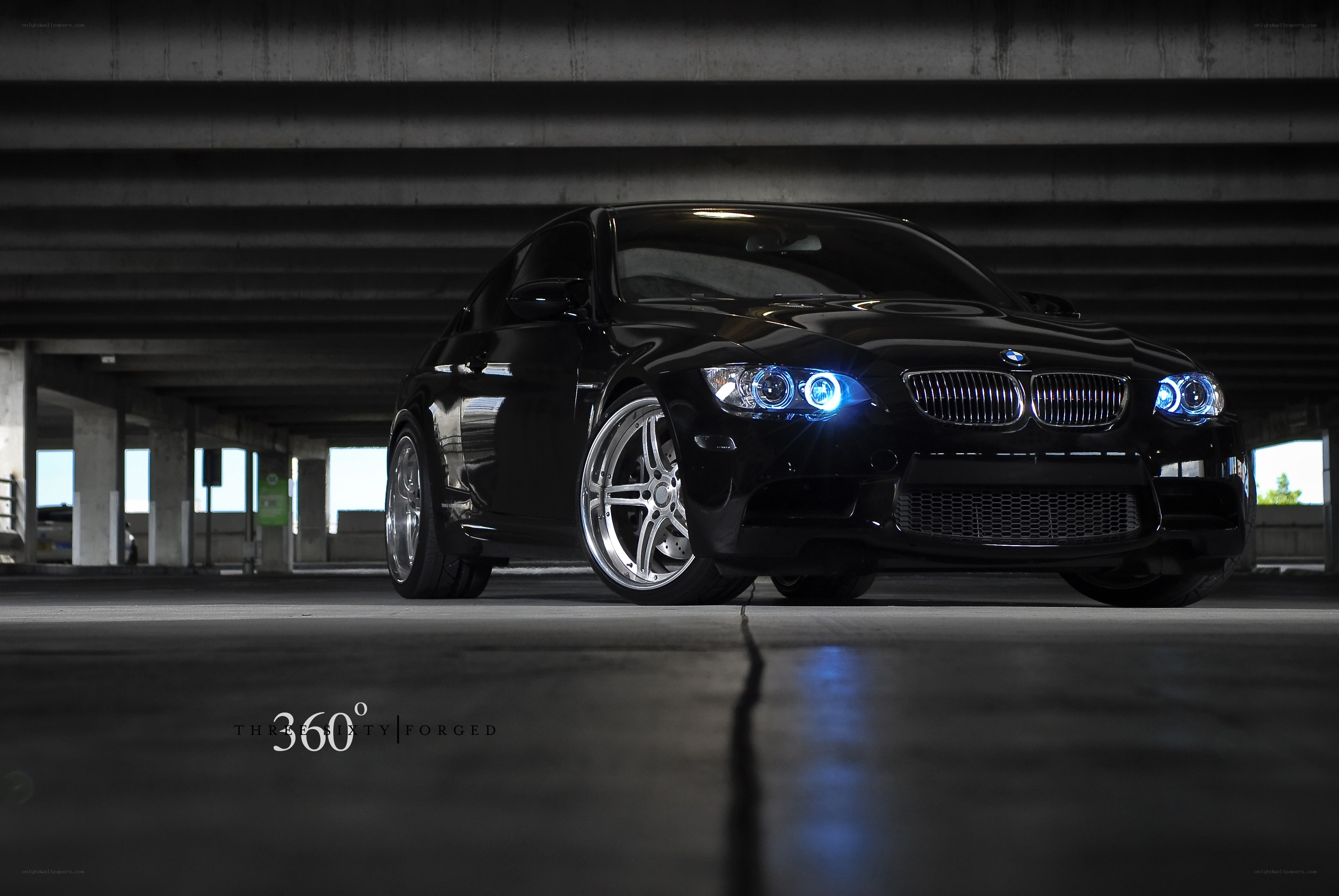 Black BMW with blue headlights