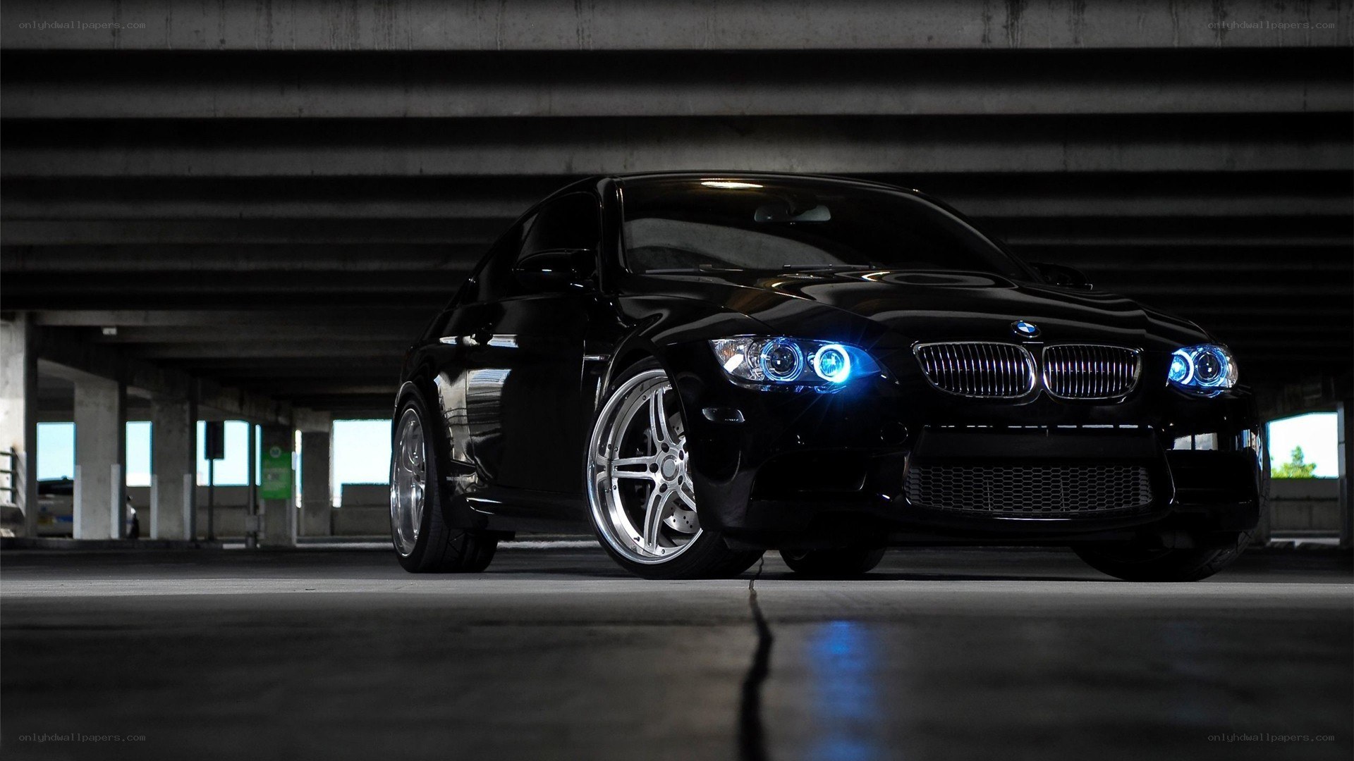 Black BMW with blue headlights