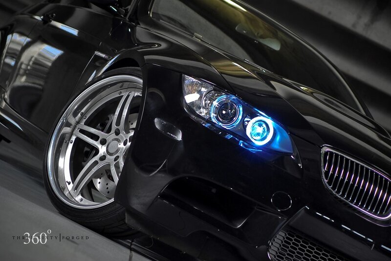 Black BMW with blue headlights