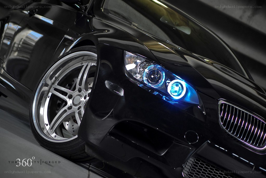 Black BMW with blue headlights
