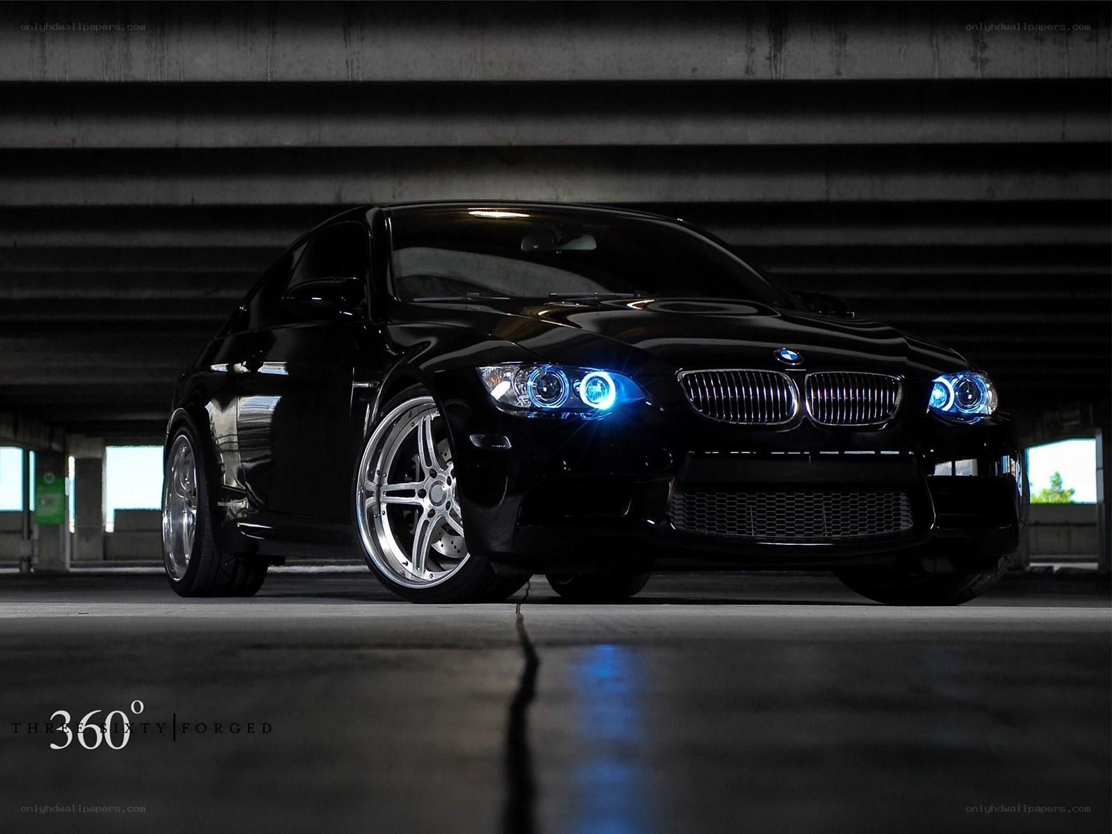 Black BMW with blue headlights