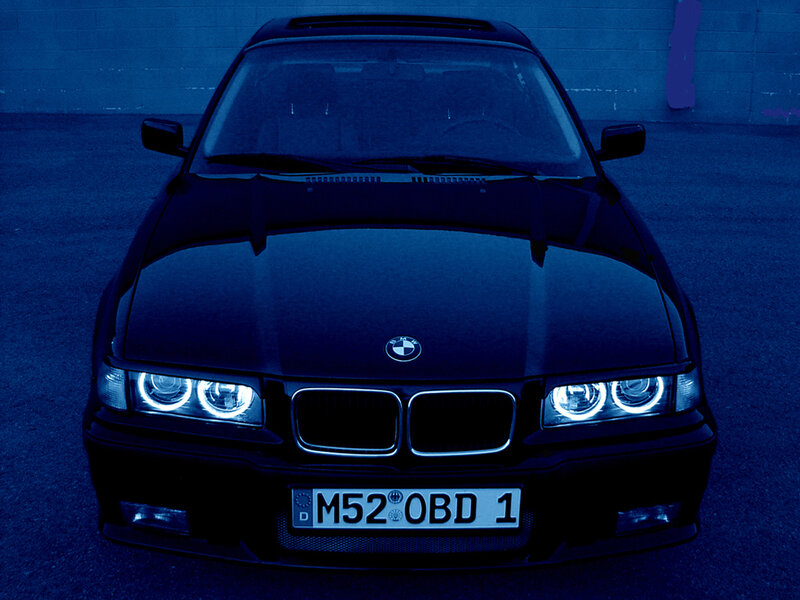 black bmw with headlights on