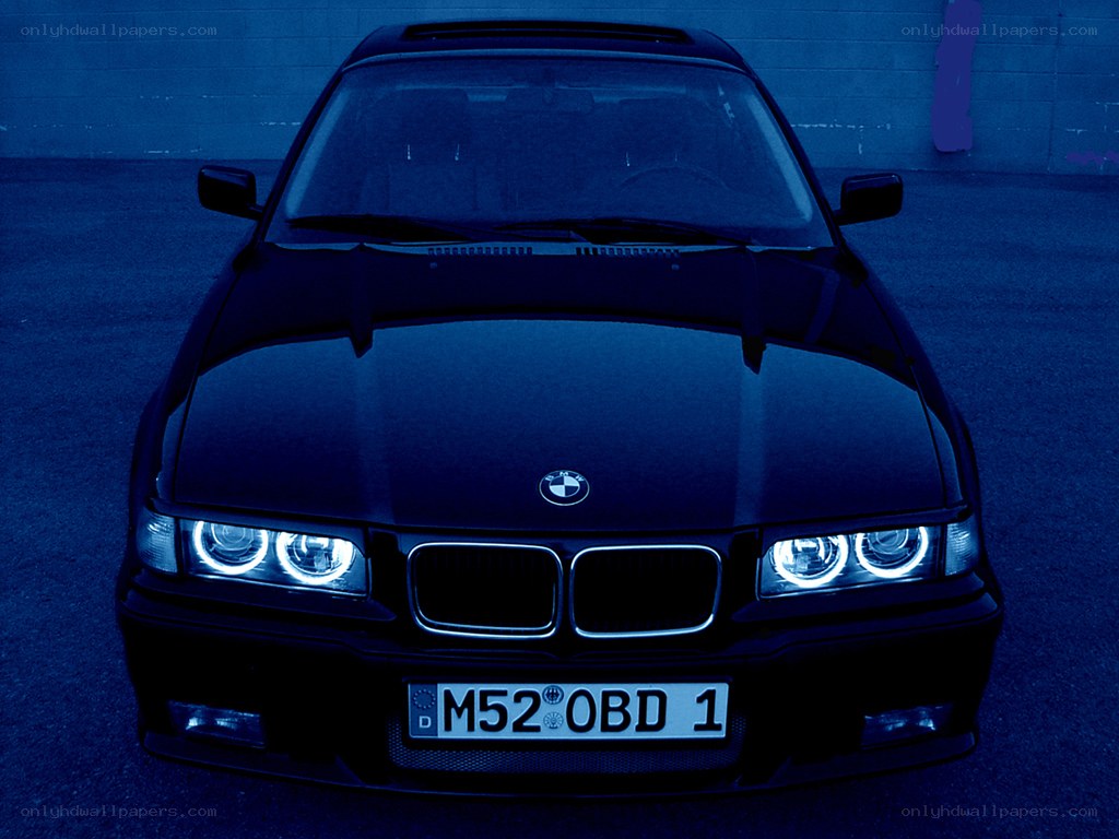 black bmw with headlights on