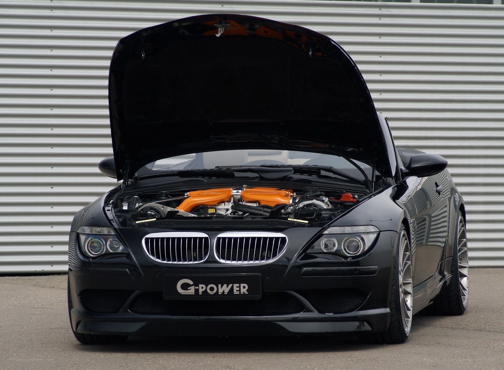 Black BMW with open hood