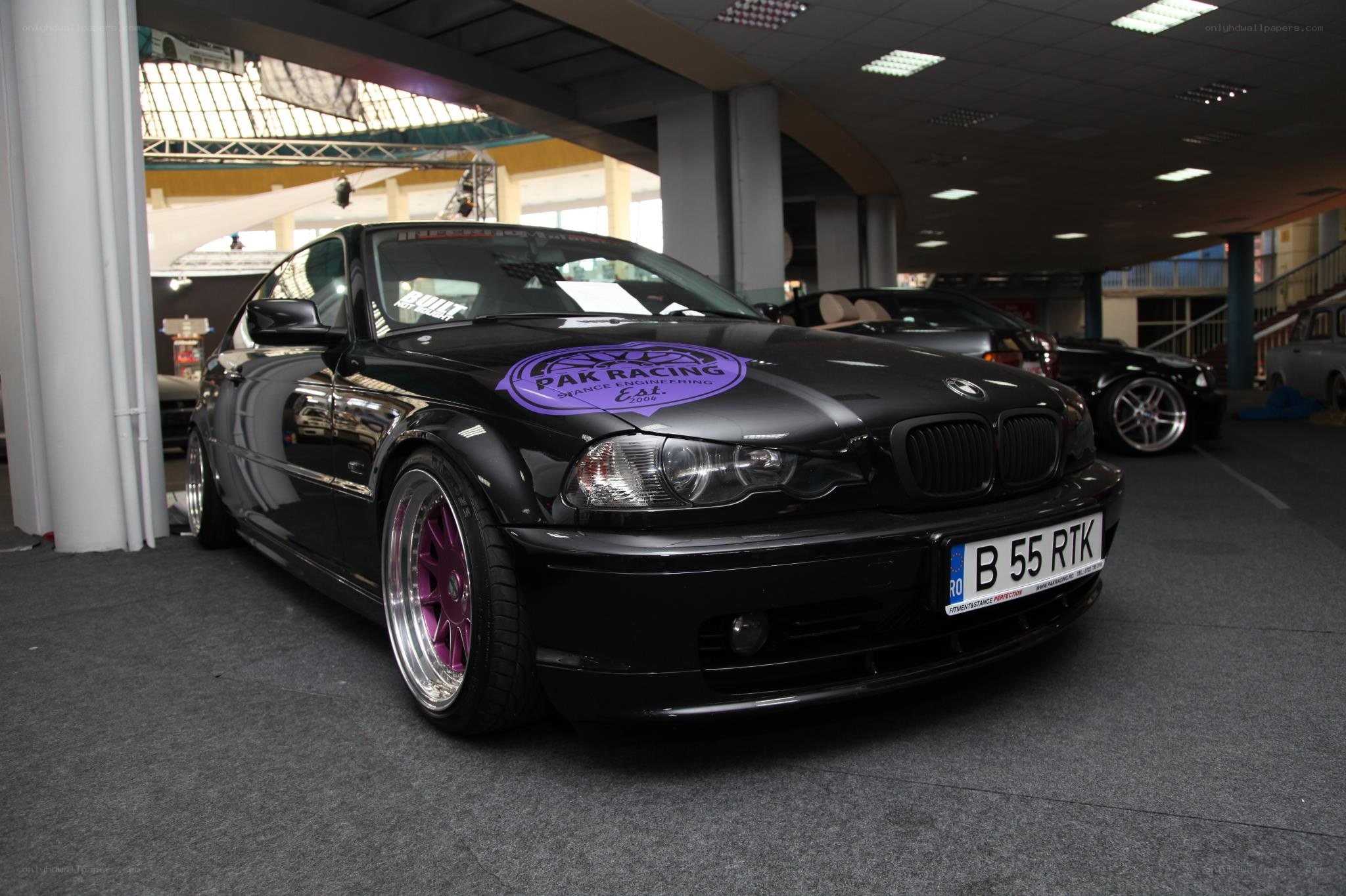 Black BMW with purple wheels