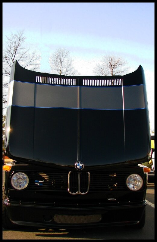 Black BMW with raised hood