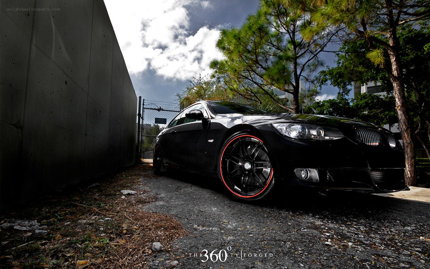 Black BMW with red rims