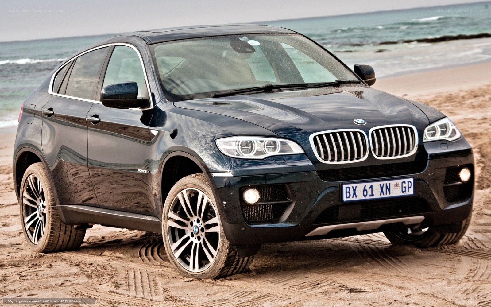Black BMW X6 on beach