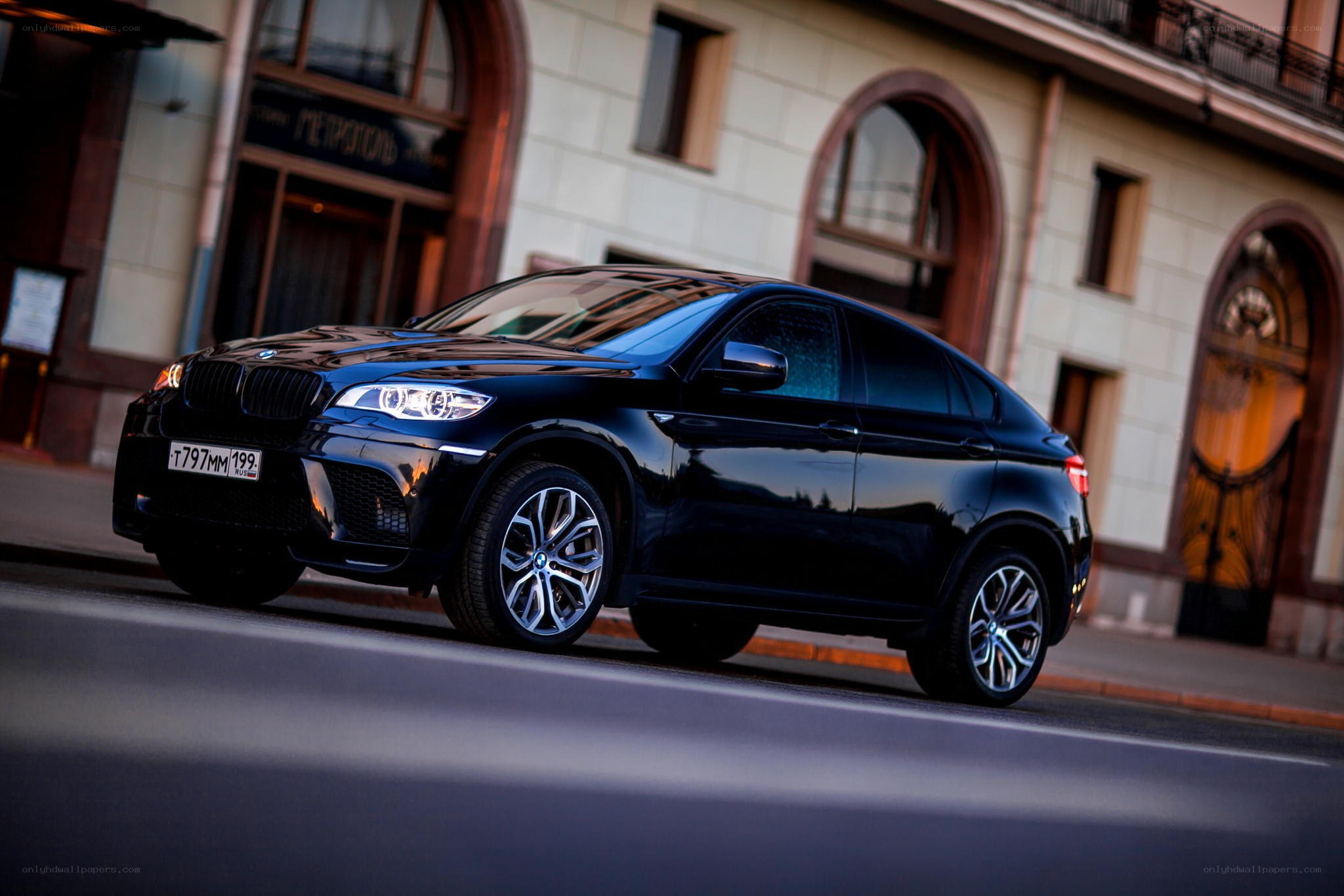 Black BMW X6 on city street