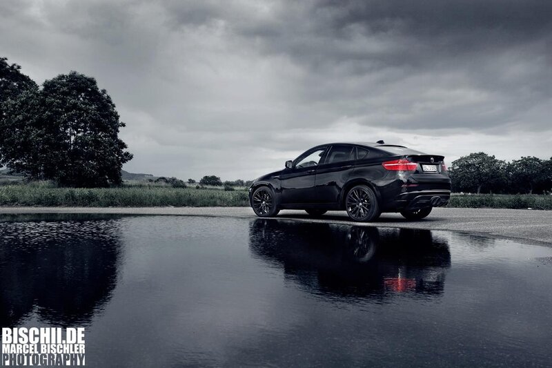 Black BMW X6 on wet road