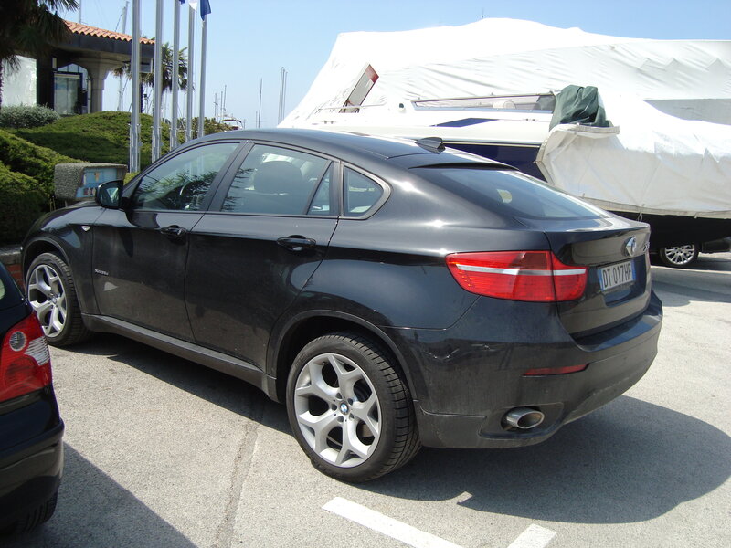 Black BMW X6 parked at marina