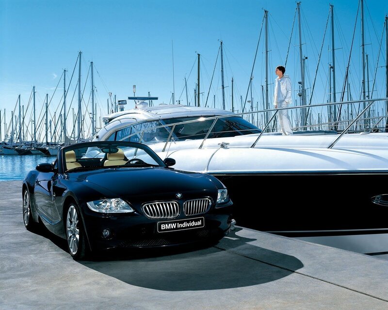 Black BMW Z4 by a yacht