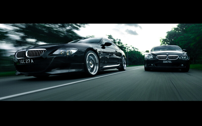 Black BMWs on a road