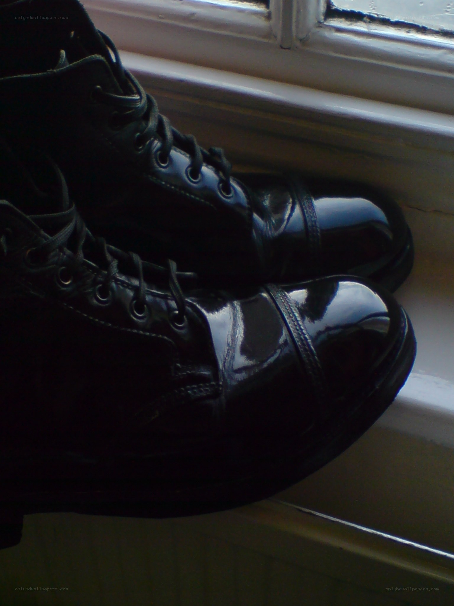 black boots on windowsill