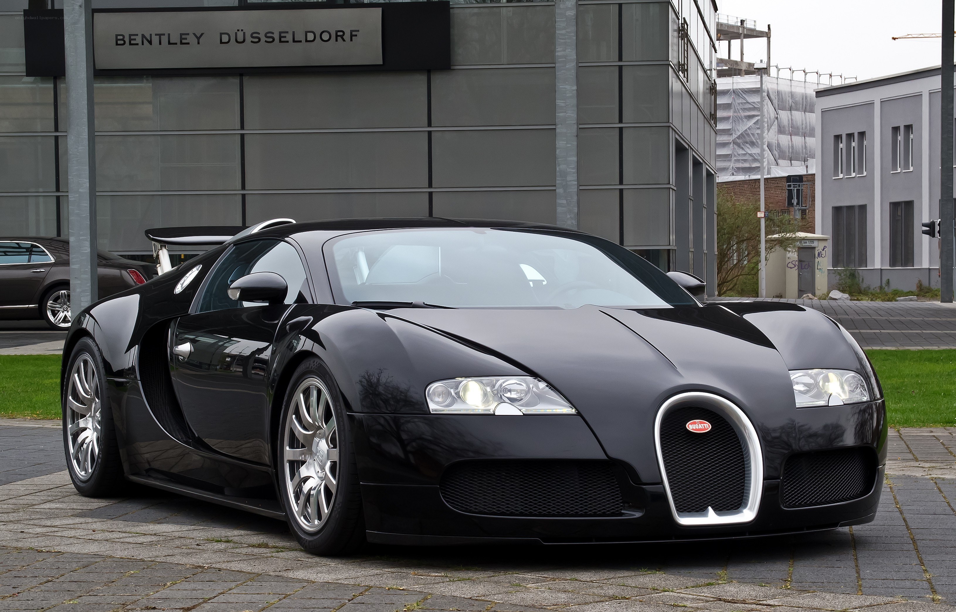 Black Bugatti Veyron parked outside dealership
