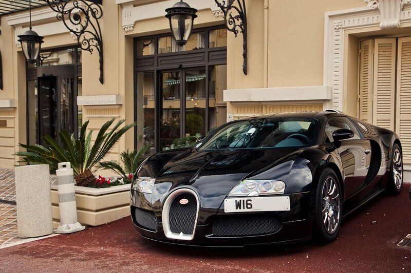 Black Bugatti Veyron parked outside hotel