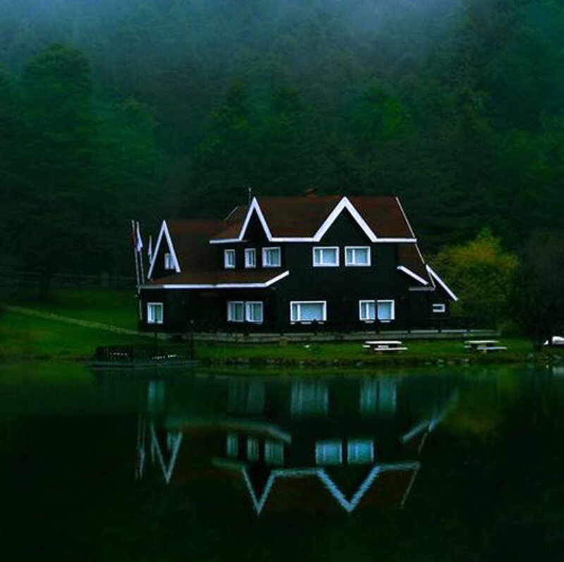 Black Cabin by Lake