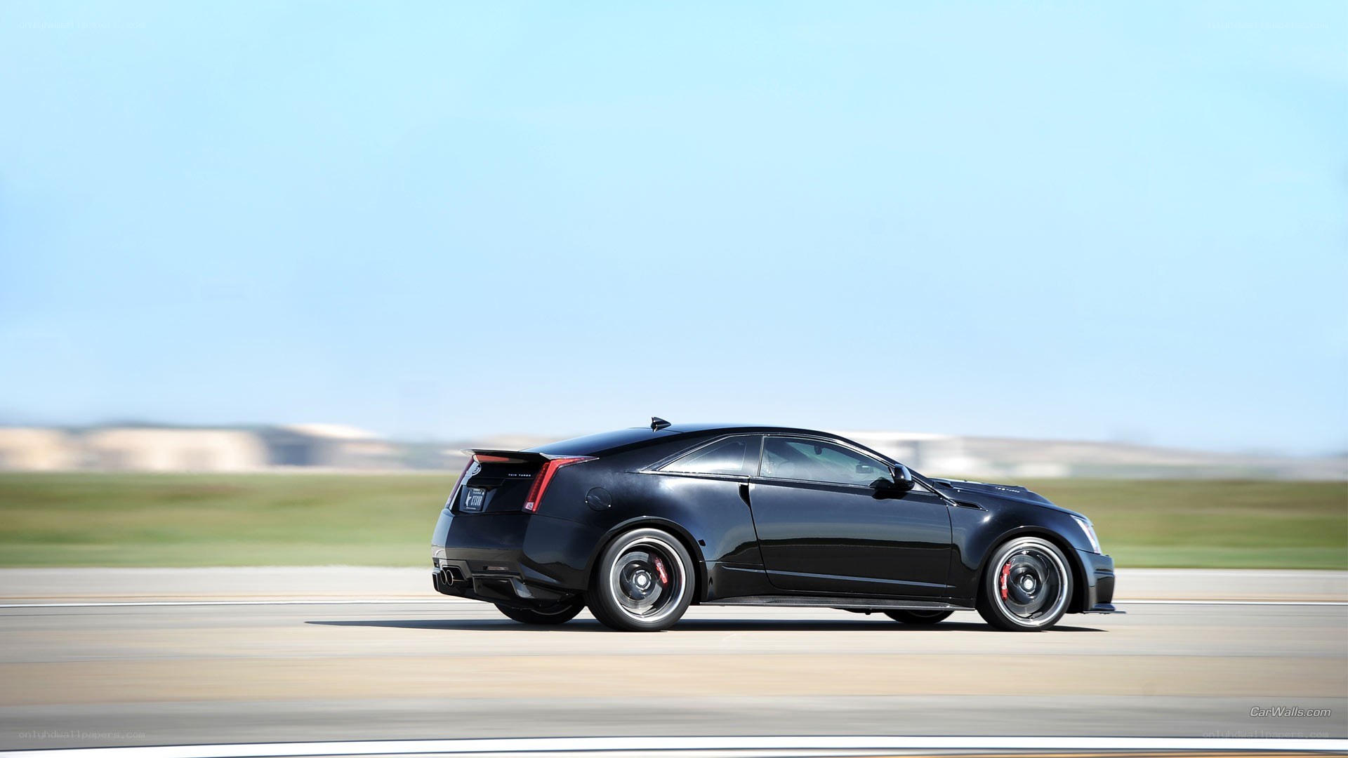 black cadillac coupe on track