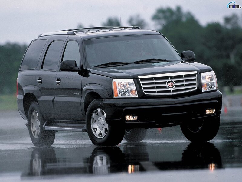 Black Cadillac Escalade on wet road