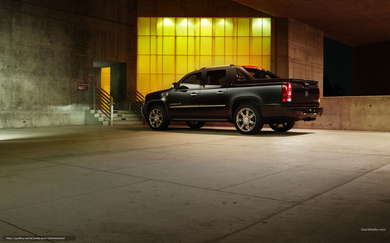 Black Cadillac pickup in garage