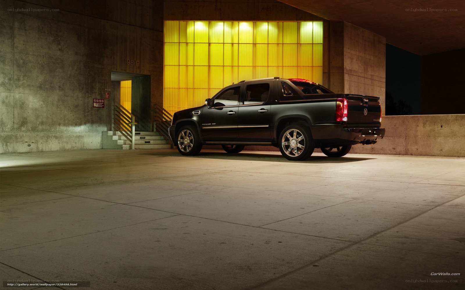 Black Cadillac pickup in garage